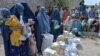 Afghan women receive food donations as part of the World Food Program (WFP) for displaced people, during the Islamic holy month of Ramadan in Jalalabad, Apr. 20, 2021.