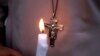 FILE - A Pakistani nun holds a candle during a vigil for victims of a deadly suicide bombing in a park, March 28, 2016, in Lahore.