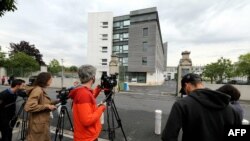 Journalists stand in front of the Sebastopol hospital in Reims, eastern France, on the day Vincent Lambert, a quadriplegic man who has been in a vegetative state for the last decade has died, on July 11, 2019. 