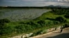 A woman walks next to a highly contaminated pond around the grounds of the Danang airbase in Danang, Vietnam, May 21, 2007