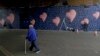 Australian street artist James Cochran, also known as Jimmy C, works, March 26, 2018, on his mural with eight hearts, each representing one of the eight victims of the attack that took place on London Bridge and around Borough Market in 2017.