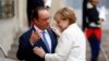 French President Francois Hollande, left, greets German Chancellor Angela Merkel prior to their meeting at the Elysee Palace in Paris, Thursday, Sept. 15, 2016.