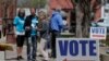 FILE - Electioneers greet voters outside the Hamilton County Government Center during early voting in Noblesville, Indiana, April 27, 2018.