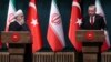 FILE - Turkish President Recep Tayyip Erdogan and his Iranian counterpart, Hassan Rouhani, hold a joint news conference after their meeting in Ankara, Dec. 20, 2018.