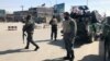 FILE - Policemen keep watch near the side of an attack in Kabul, Afghanistan, March 7, 2019.