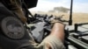 FILE - A soldier of France's Barkhane mission holds a weapon as he patrols in central Mali, in the border zone with Burkina Faso and Niger, Nov. 01, 2017. 