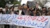 Pakistani journalists rally against killings of their fellow journalists holding a banner that reads, "Protect journalists, killers of the tribal journalists should be arrested," in Peshawar, Pakistan on Tuesday, Feb. 8, 2005. An international media righ