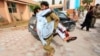 An injured man is carried to a hospital after a car bomb in Jalalabad city, Afghanistan, June 17, 2018.