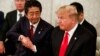 President Donald Trump, right, and Japanese Prime Minister Shinzo Abe shake hands during a meeting with Japanese families of those abducted by North Korea, at Akasaka Palace, Monday, May 27, 2019, in Tokyo.