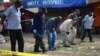 Forensic teams search for evidence at the scene of a bomb blast in the Somali district of Eastleigh, in Nairobi, April 1, 2014. 
