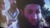 FILE - In this file image made from video broadcast on Thursday, Nov. 7, 2013, undated footage of Mullah Fazlullah is shown on a projector in Pakistan.