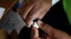 FILE - A member of the vaccination campaign against cholera opens a vial at the Immaculate Conception Hospital in Les Cayes, Haiti, Nov. 8, 2016. 