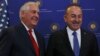 U.S. Secretary of State Rex Tillerson, left, and Turkey's Foreign Minister Mevlut Cavusoglu stop for photographers prior to their meeting in Ankara, March 30, 2017.