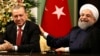 FILE - Iran's President Hassan Rouhani, right, laughs during a during a joint press conference with Turkey's President Recep Tayyip Erdogan following their meeting at the Saadabad Palace in Tehran, Iran, Oct. 4, 2017.
