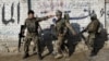 FILE - Afghan National Army (ANA) soldiers arrive after a blast near the Pakistani consulate in Jalalabad, Afghanistan, Jan. 13, 2016.