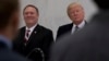 FILE - President Donald Trump, accompanied by then-CIA Director-designate Mike Pompeo, left, waits to speak at the Central Intelligence Agency in Langley, Virginia, Jan. 21, 2017.