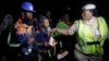 An unidentified Immigration officer, right, speaks to Nigerian returnees from Libya upon arrival at the Murtala Muhammed International Airport in Lagos Nigeria, Dec. 5, 2017. 