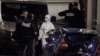French police and forensic investigators stand outside the offices of French satirical weekly Charlie Hebdo in Paris, Jan. 7, 2015, after armed gunmen stormed the offices leaving 12 dead. 