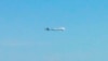 FILE - An unidentified plane flies near disputed islands in the air over the East China Sea, in this handout photo taken by Japan Air Self-Defence Force and released by Joint Staff of the Defense Ministry of Japan.
