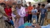 An Indian election official, only hands seen, demonstrates how to use an electronic voting machine during an awareness drive in New Delhi, India, March 29, 2019, ahead of general elections.