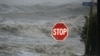 Isaac's winds and storm surge overcome a seawall and flood South Beach Boulevard, Waveland, Miss., Aug. 29, 2012.