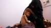 FILE - The mother of Radhi Awadh, 2, holds him at a malnutrition treatment ward of al-Sabeen hospital in Sanaa, Yemen, Feb. 13, 2021. 