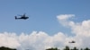 FILE - AH-64 Apache helicopters fly during a live-fire drill of the U.S. Army's 1st Armored Brigade Combat Team, 1st Armored Division at the Rodriguez Live Fire Complex, in Pocheon, South Korea, Aug. 14, 2024.