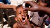FILE - A health worker drops anti-polio vaccine into the mouth of a Somali child in Mogadishu September 10, 2006.