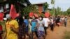 This handout photo taken and released by Dawei Watch on May 5, 2021, shows protesters holding signs during a demonstration against the military coup in Dawei, Myanmar.
