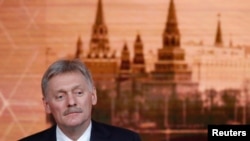 FILE - Kremlin spokesman Dmitry Peskov listens during Russian President Vladimir Putin's annual end-of-year news conference in Moscow, Russia, Dec. 19, 2019. 
