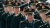 Chinese military officers are shown the way as they arrive outside the Great Hall of the People in Beijing, China, March 4, 2013. 