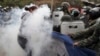 Supporters of opposition presidential candidate Salvador Nasralla struggle with military police for possession of a giant Honduran flag at the Policarpo Paz Garcia neighborhood of Tegucigalpa, Jan. 20, 2018.