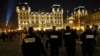 FILE - French police officers patrol near Notre Dame Cathedral as worshippers arrive for the Christmas eve mass in Paris, Dec. 24, 2016.