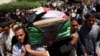 Residents carry a coffin during the funeral of an Iraqi soldier in Baghdad, April 25, 2013.
