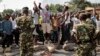 FILE - Oposition demonstrators confront army soldiers in the Mutarakura district, as security forces try to prevent people from moving out of their neighborhoods, in the capital Bujumbura, Burundi.