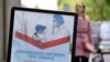 A advertising sign for a coronavirus disease (COVID-19) antibody test service is seen outside a pharmacy, in London, Britain, June 29, 2020. REUTERS/Toby Melville