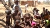FILE - Children shelter from the sun in Ankilimarovahatsy, Madagascar, a village in the far south of the island where most children are acutely malnourished, Nov. 9, 2020. 