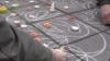 People scrawl messages on the sidewalk at the Place de la Bourse in downtown Brussels in response to the terrorist attacks that left dozens of people dead, March 23, 2016. (L. Bryant/VOA)