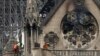 FILE - Experts inspect the damaged Notre Dame cathedral after the fire in Paris, April 16, 2019, assessing the blackened shell of Paris' iconic cathedral to establish next steps to save what remains after a devastating fire destroyed much of the almost 900-year-old building.