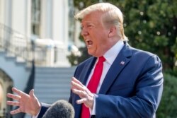 President Donald Trump speaks to reporters on the South Lawn of the White House in Washington, Aug. 7, 2019, before heading to Dayton, Ohio, and El Paso, Texas.