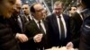 France's President Francois Hollande, center, samples some cheese as he visits the Paris international agricultural fair, Feb. 21, 2015.