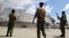 FILE - Armed police guard the Salvation Army Church after it was set on fire by rioting youths, following Friday Muslim prayers in Mombasa, Kenya, Oct. 4, 2013.