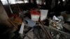 Documents, ballot boxes and debris are seen, as security personnel inspect the site of a suicide attack on the electoral commission in Tripoli, Libya, May 2, 2018.