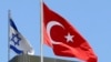 FILE - A Turkish flag flutters atop the Turkish embassy as an Israeli flag is seen nearby, in Tel Aviv, Israel, June 26, 2016.