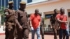 Tanzania's main opposition Chadema party leader Freeman Mbowe (center, in red shirt) arrives at the High Court in Dar es Salaam, Tanzania, Feb. 18, 2022.