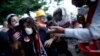 FILE - In this June 11, 2013, photo, a protester affected by tear gas is helped by other protesters to a field hospital in Gezi Park in Taksim Square in Istanbul, Turkey.