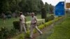 FILE - Indian policemen secure the area outside the Pakistan High Commission as Kashmiri separatist leaders arrive for talks with the Pakistani high commissioner in New Delhi, India.