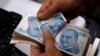 A money changer counts Turkish lira notes at a currency exchange office in Istanbul, Aug. 2, 2018. The lira has taken a beating since U.S. sanctions were applied in the case of a detained pastor, Andrew Brunson.