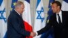 French President Emmanuel Macron and Israel's Prime Minister Benjamin Netanyahu shake hands as they attend a joint press conference at the Elysee Palace in Paris, June 5, 2018.