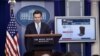 White House press secretary Josh Earnest uses a graphic to discuss the Trans-Pacific Partnership during the daily briefing at the White House in Washington, Oct. 13, 2015.